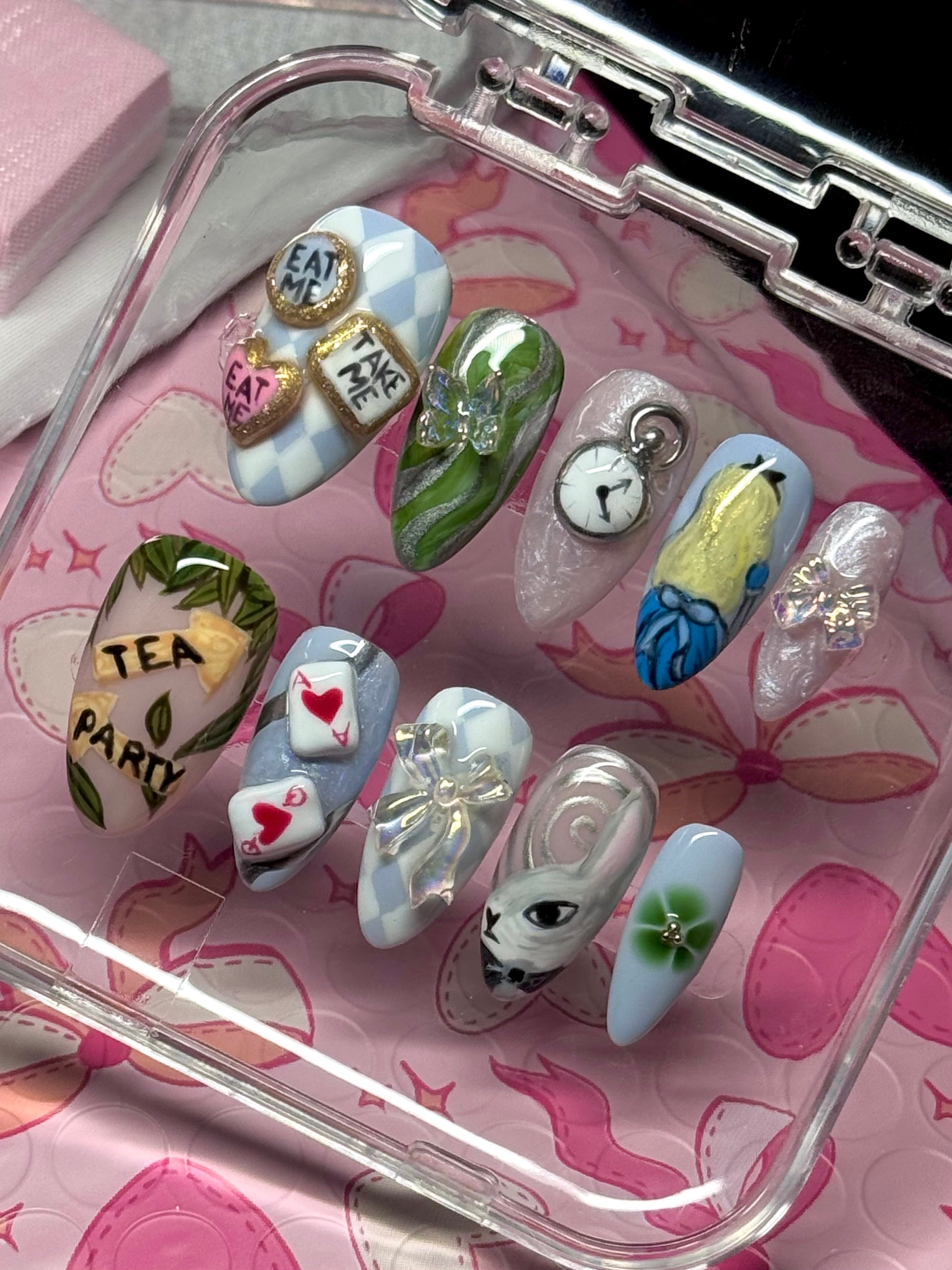 nail art designs in a clear case on a pink floral background
